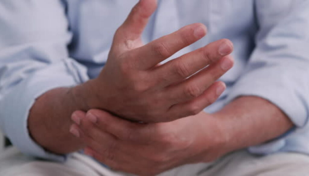 An elderly man's hand is trembling because of Parkinson's disease.