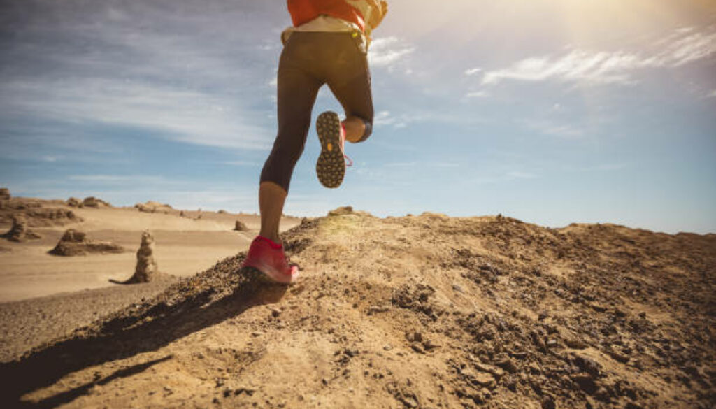 Fitness woman cross country running in the desert