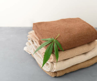 Stack of hemp clothes with cannabis leaf