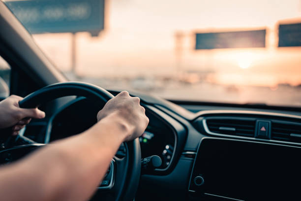 Close-up - Hand of man driving car on the road. CBD und Autofahren
